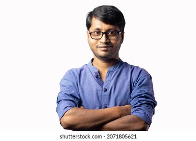 A young Indian male in blue dress smiles looking at camera with arms closed on white background - Shutterstock ID 2071805621