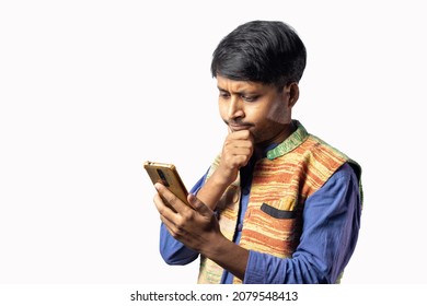 A Young Indian Male In Blue Dress With Thoughtful Face Holding Smart Phone On White Background