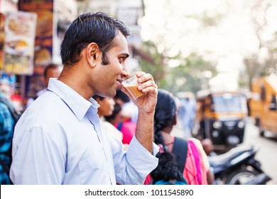 Young Indian Man Drinking Tea At The Market