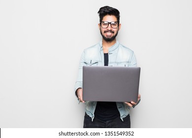 Young Indian Man In Eyesglasses And Casual Wear Holding Laptop White Standing On White Background