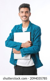 Young Indian Man Holding Laptop In Hand On White Background.