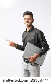 Young Indian Man Holding Laptop In Hand On White Background.