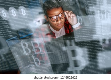 Young indian man mining cryptocurrency at night