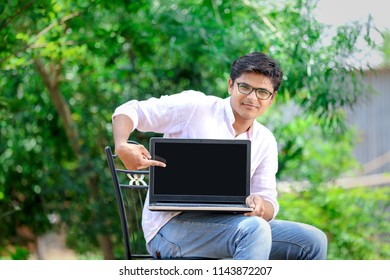 Young Indian Man Showing Laptop Screen