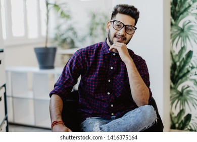 Young Indian Man Sitting In Chair In His Modern Office