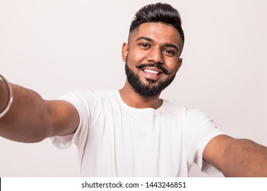 Young indian man taking selfie isolated on white background