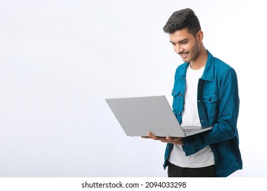 Young Indian Man Using Laptop On White Background.