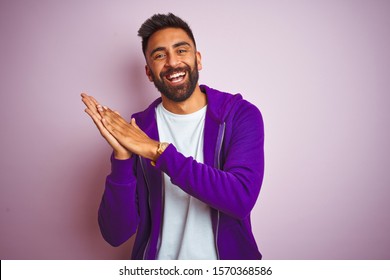 Young Indian Man Wearing Purple Sweatshirt Standing Over Isolated Pink Background Clapping And Applauding Happy And Joyful, Smiling Proud Hands Together