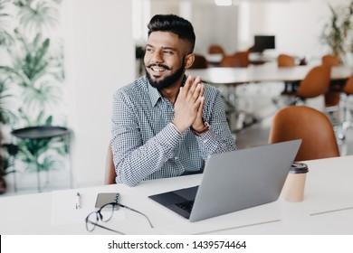 Young Indian Man Working On Laptop In Modern Office