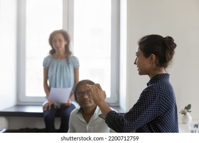 Young Indian mentor training diverse group of interns in office. Millennial business woman talking to team of employees in corporate meeting, Side view. Female leadership concept - Shutterstock ID 2200712759