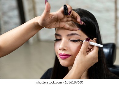 A Young Indian Model At A Beauty Salon, Makeup Artist Applying Eyeliner On Customer.