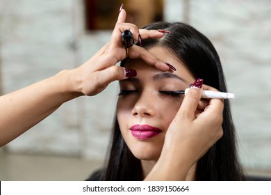 A Young Indian Model At A Beauty Salon, Makeup Artist Applying Eyeliner On Customer.