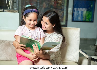 Young Indian Mother Helping Little Daughter With Study At Home, Asian Girl Child With Notebook Doing Homework With Her Mom.