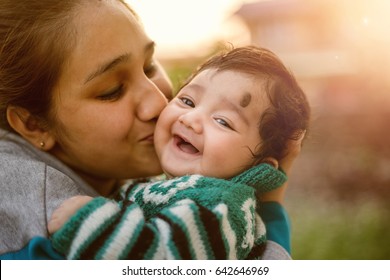 Young Indian Mother Kissing Her Beloved Baby