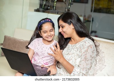 Young Indian Mother Teach Daughter How To Use Laptop Computer At Home. Asian Girl Child Study Online Education, English Lesson. Tell Story.