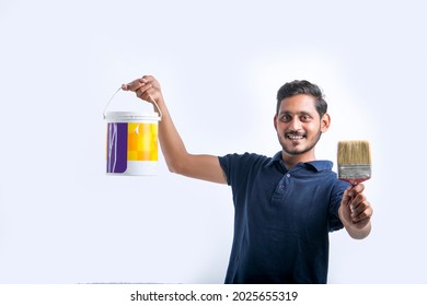 Young indian Painter man over white background.