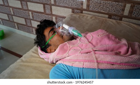 Young Indian Taking Emergency Oxygen With Cannula Outside Of Hospital. Severe Causes Due To Covid In India Concept