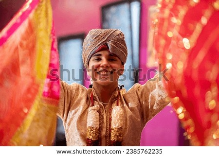 young indian teenager looking at camera while holding bollywood dance veils