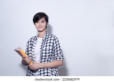 Young Indian urban teenager school or college girl holding notebooks in hand isolated on white background. Copy space. - Powered by Shutterstock