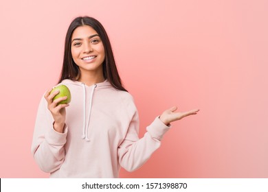 Young Indian Woman Eating An Apple