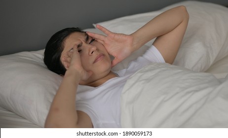 Young Indian Woman With Headache Laying In Bed