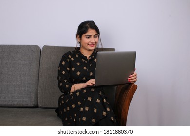 Young Indian Woman Or Housewife Working On Laptop. 