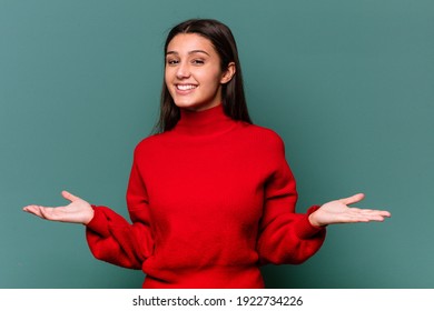 Young Indian woman isolated on blue background showing a welcome expression.