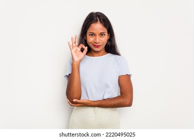 Young Indian woman isolated on white background winks an eye and holds an okay gesture with hand. - Shutterstock ID 2220495025