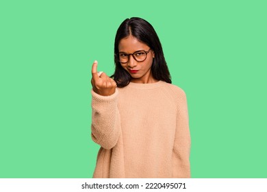 Young Indian Woman Isolated Pointing With Finger At You As If Inviting Come Closer.