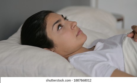 Young Indian Woman Laying Awake In Bed