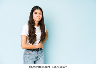 Young Indian Woman On Blue Background Having A Liver Pain, Stomach Ache.