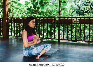 Young Indian Woman Practicing Yoga And Meditation During Vacation Yoga Retreat In Bali