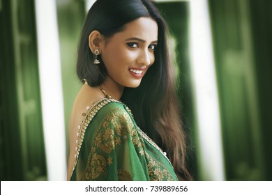 Young Indian woman wearing green dress	
