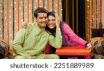 Young Indians siblings showing love and care - brother-sister relationship - Raksha Bandhan concept, Indian Model . Good looking adults in traditional wear. Cute brother teasing and giving gift to ...