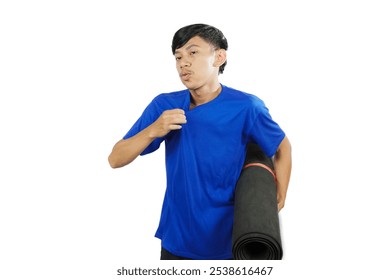 Young Indonesian man in blue shirt tired while exercising while carrying exercise mat, concept of healthy lifestyle with sufficient exercise, isolated on white background. - Powered by Shutterstock