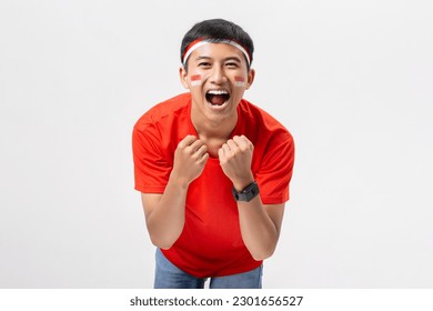 Young Indonesian man very happy and excited with arms raised celebrate Indonesia independence day 17 August isolated on white background. Dirgahayu 78 Tahun Kemerdekaan Indonesia. - Powered by Shutterstock