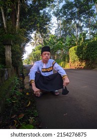 A Young Indonesian Muslim Guy Squatting Down