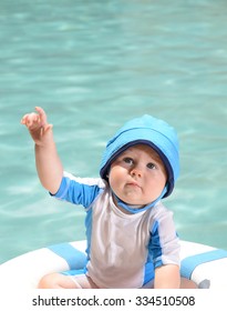 Young Infant At Pool With Life Preserver Or Lifesaver For A Water Safety Concept