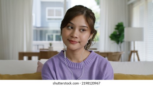 Young Influencer Vlogger Teen Girl Asia People Sit Easy Relax At Cozy Sofa Home Selfie Vlog Live Talk Share Chat On Social Media App Screen Reel Tiktok Instagram. Model Lady Video Call Look At Camera.