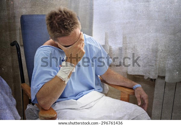 young\
injured man crying in hospital room sitting alone in pain looking\
negative and worried for his bad health condition sitting on chair\
suffering depression on a grunge medical\
background