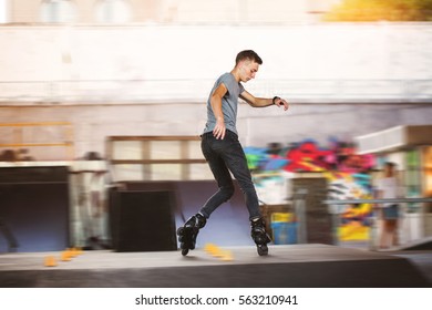 Young inline skater. Man on blurred background. Train and win.