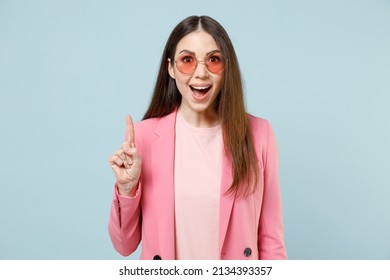 Young insighted clever smart excited proactive woman 20s in pastel pink clothes glasses hold index finger up with great new idea isolated on blue background studio portrait People lifestyle concept
