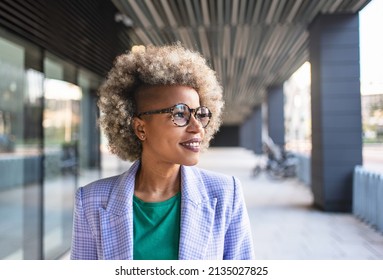 Young inspired African American business woman looking to the side. Happy successful black female professional - Shutterstock ID 2135027825