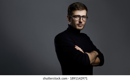 Young intelligent man wearing turtleneck and eyeglasses on gray background - Shutterstock ID 1891142971