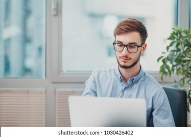 Young Intern Working At The Office