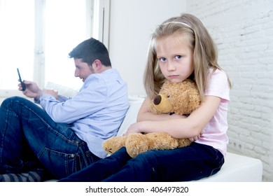 Young Internet Addict Father Using Mobile Phone Ignoring Little Sad Daughter Looking Bored Hugging Teddy Bear Abandoned And Disappointed With Her Dad In Parent Bad Selfish Behavior