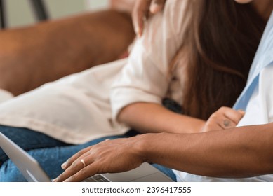 Young interracial couple live together at home in relationship and friendship and use laptop smiling. Happy people and love concept. Use of internet wireless technology. Boy and girl indoor leisure - Shutterstock ID 2396417555