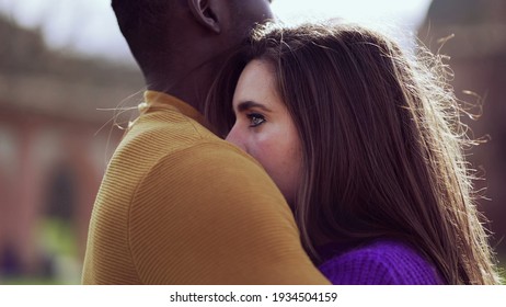 Young interracial couple together dating outside. Romantic embrace hug - Powered by Shutterstock