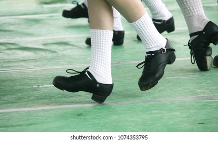 Young Irish Dance Girls Team in a Line on Stage in Hard Jig Shoes
