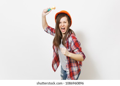 Young Irritated Dissatisfied Woman In Protective Construction Helmet Swinging Toy Hammer And Screaming Isolated On White Background. Instruments For Renovation Apartment Room. Repair Home Concept